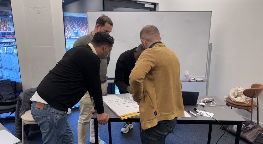 Participants working in a sub-group on a real case during a sales training